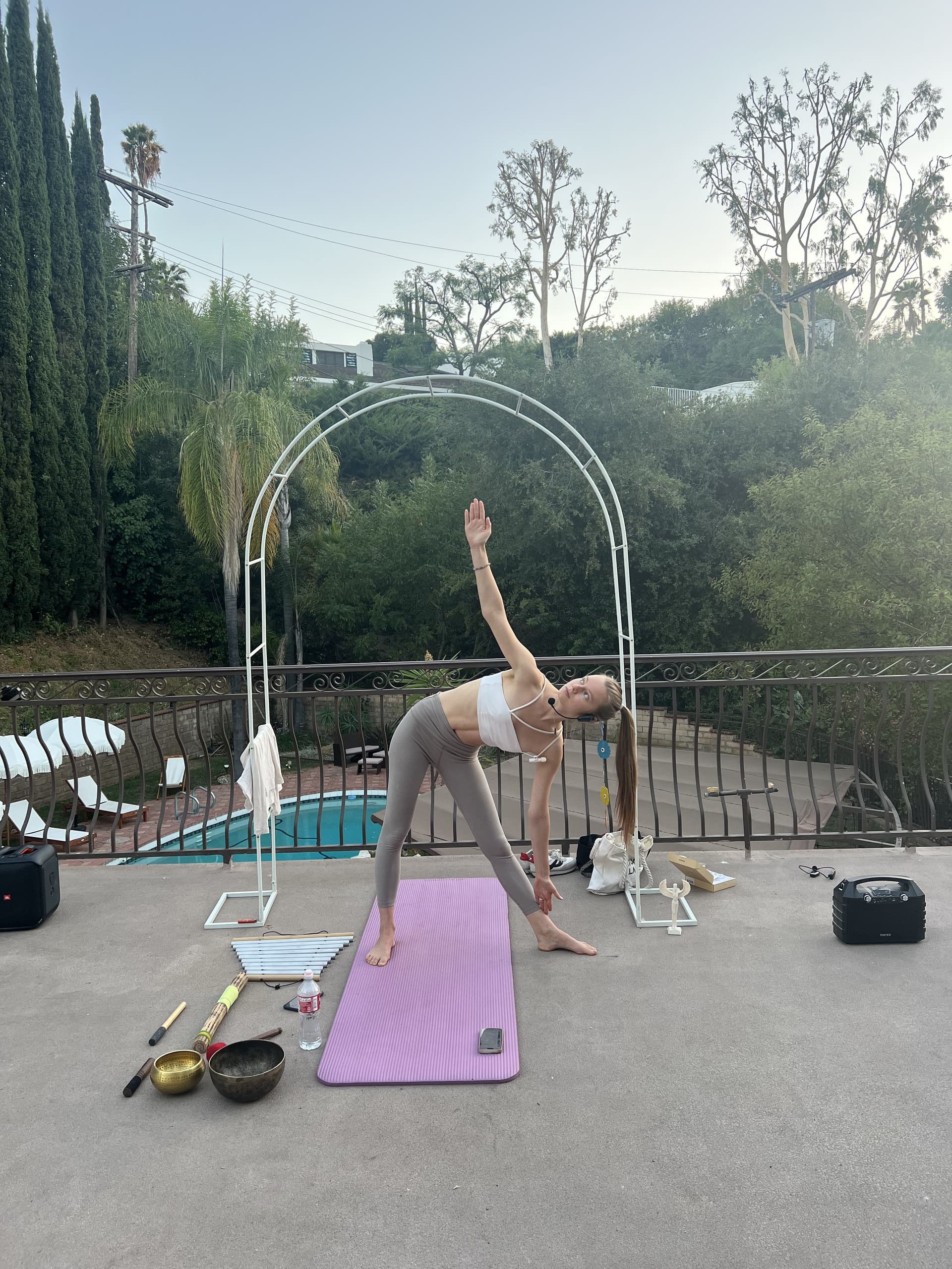 Triangle pose on poolside terrace